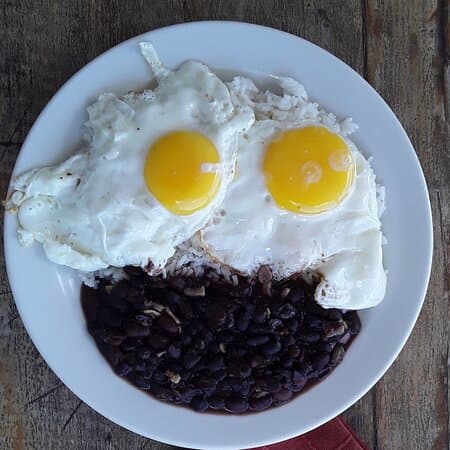Rice, beans, and fried eggs — the plate that needs no occasion. This is who we are.