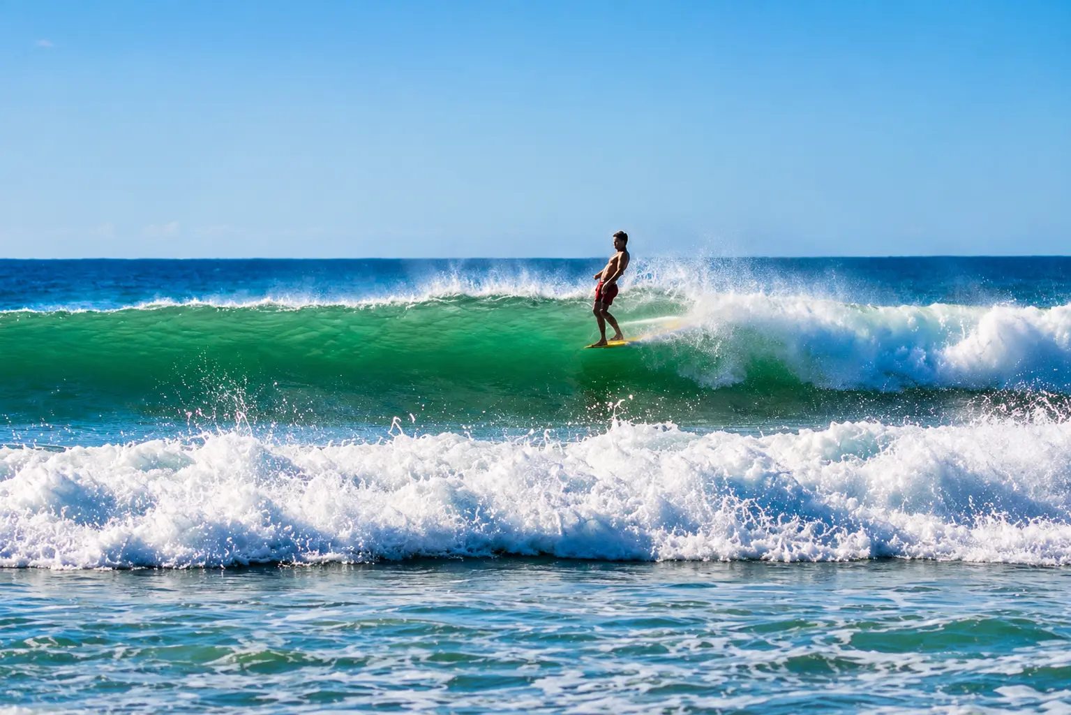 Tamarindo's beach break is forgiving, sandy-bottomed, and works almost every day of the year.